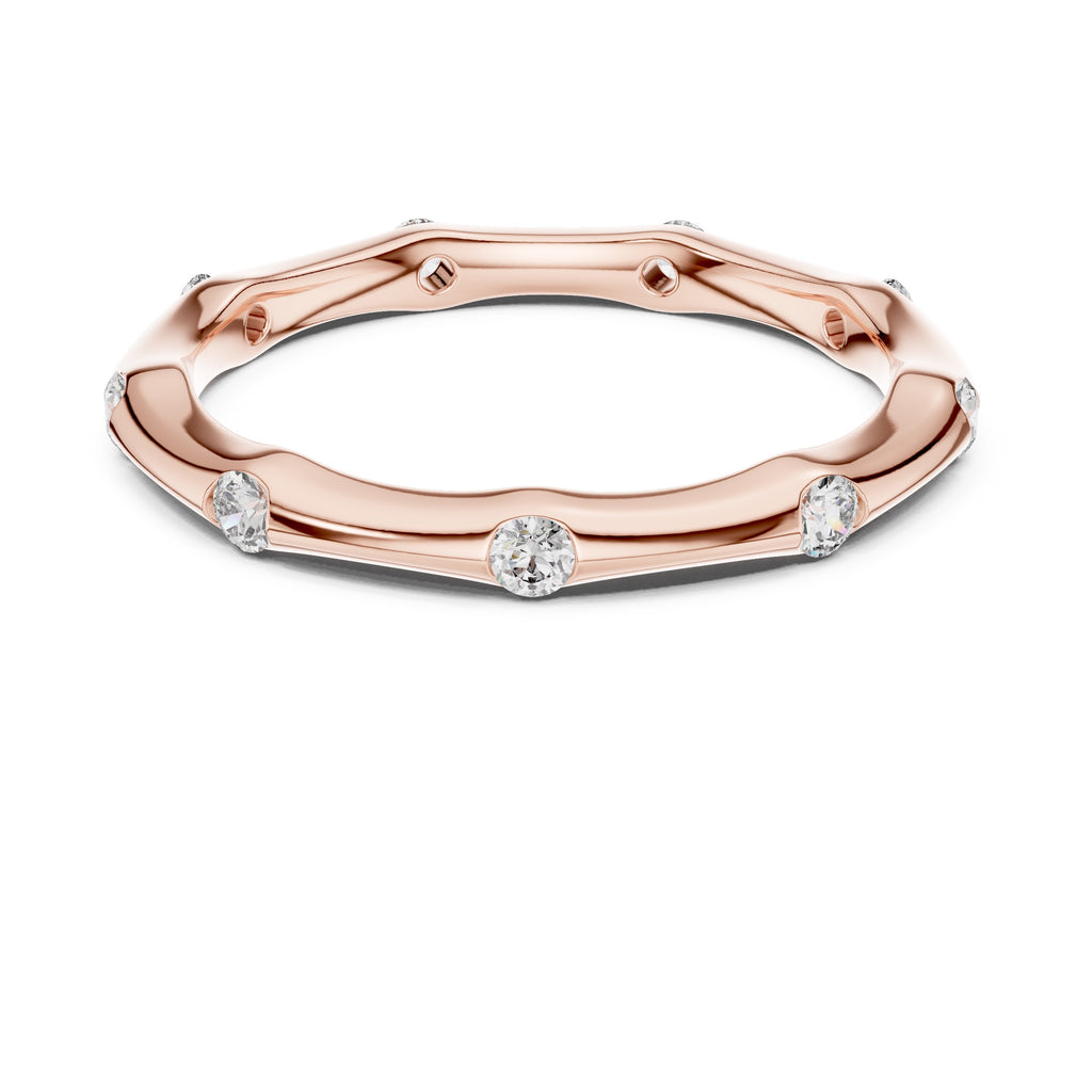 Rose gold ring with diamond accents on a white background
