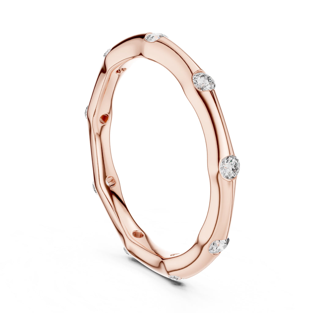 Rose gold ring with embedded diamonds on a white background