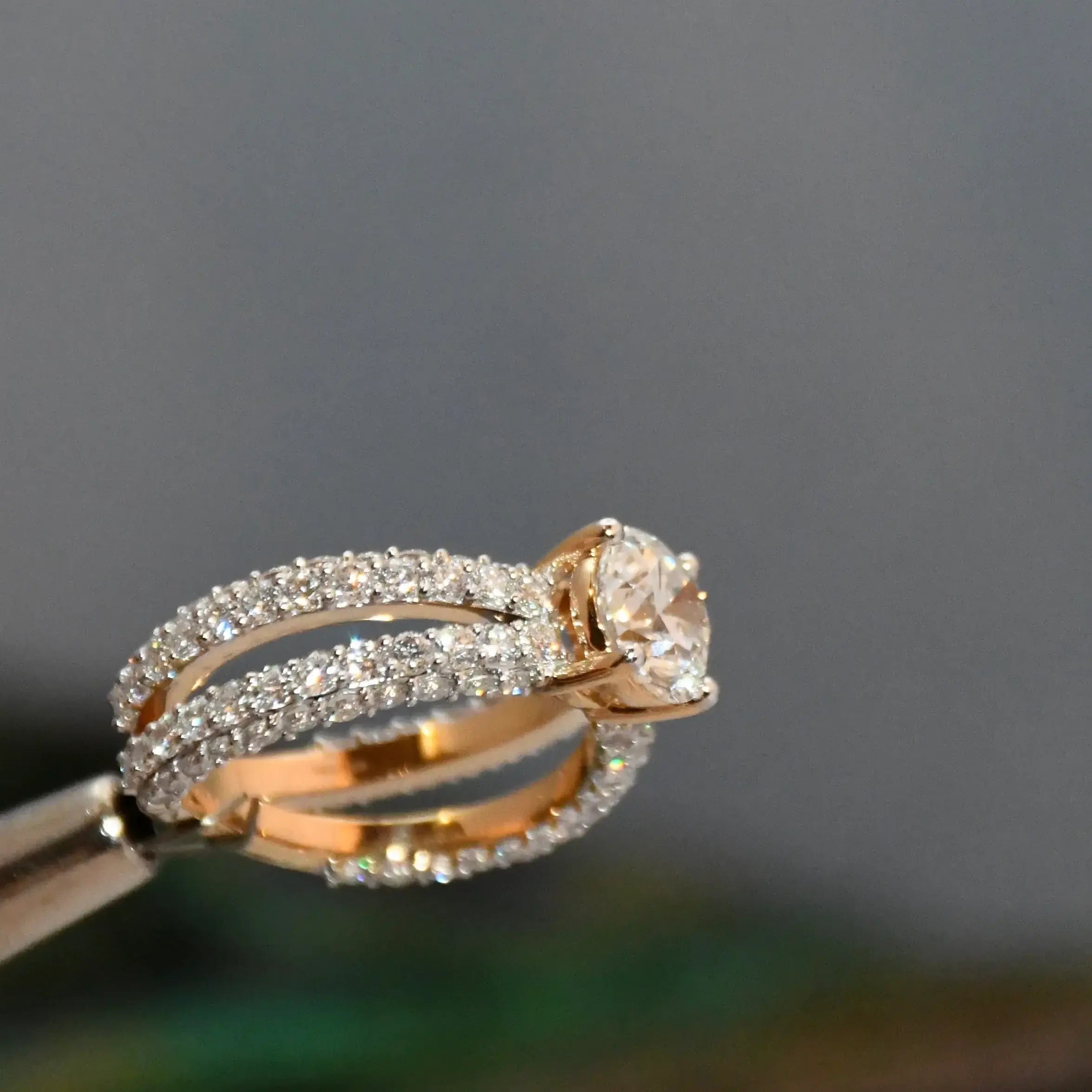 Rose gold ring with real diamond accents on a dark background