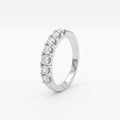 A band diamond ring with multiple diamonds set in a gold band, displayed against a white background.