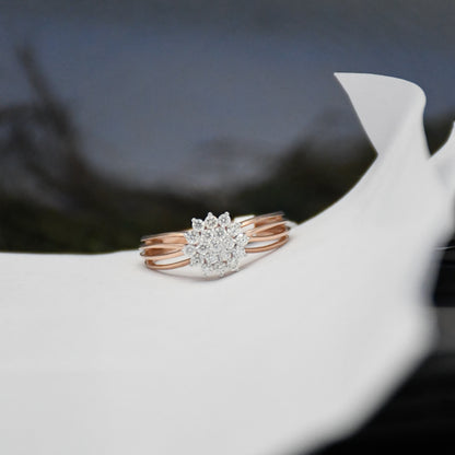 Rose gold ring with diamonds on a white surface