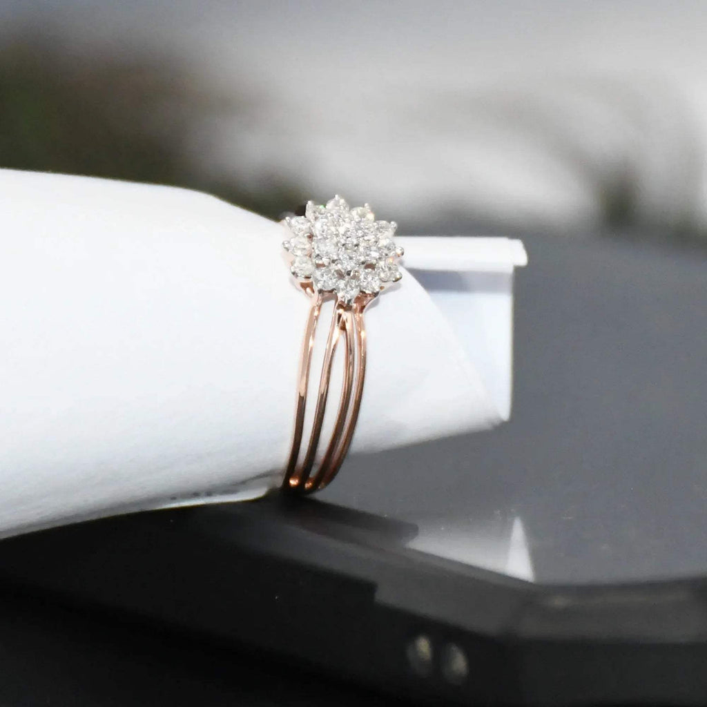 Rose gold ring with diamonds on a white surface