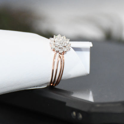 Rose gold ring with diamonds on a white surface