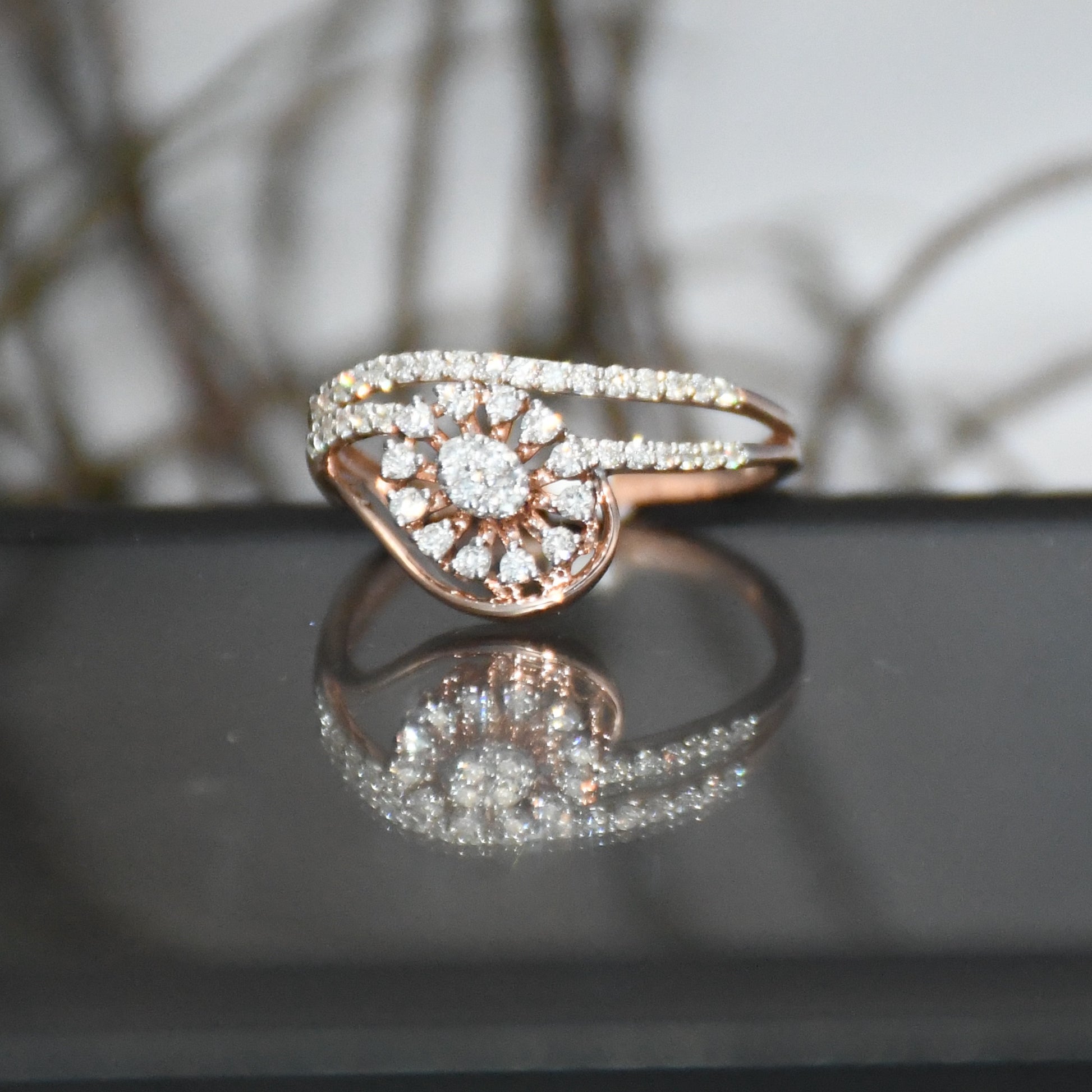 gold ring with diamonds on a reflective surface