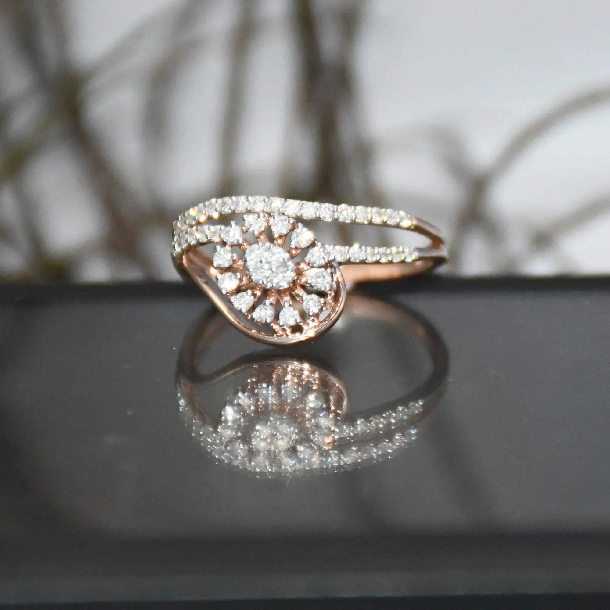 gold ring with diamonds on a reflective surface