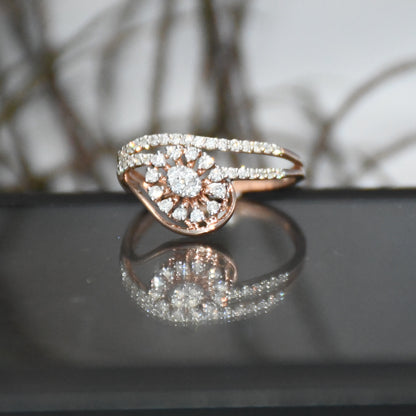 gold ring with diamonds on a reflective surface