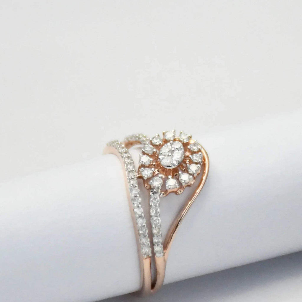 gold ring with diamond accents on a light gray background