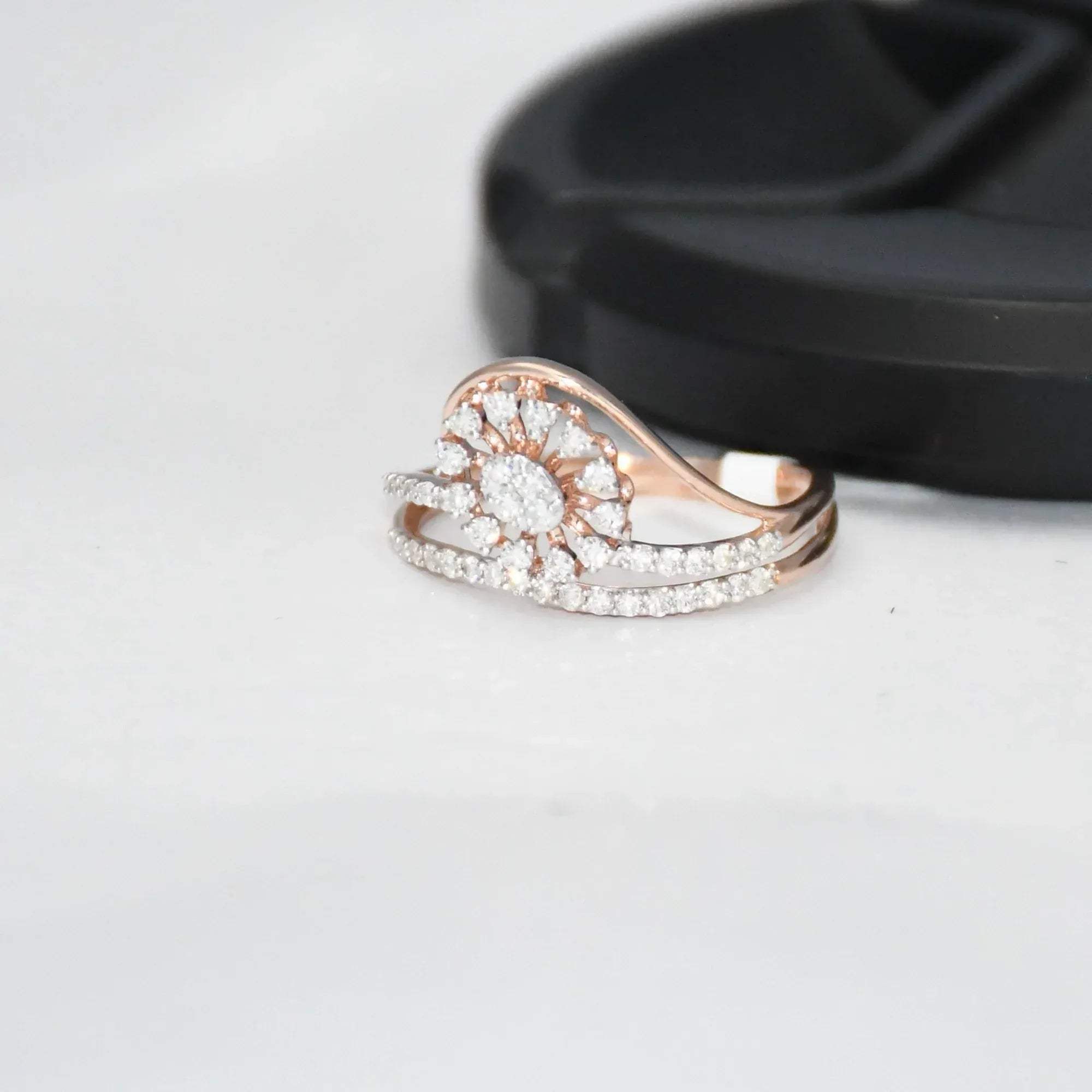 gold ring with diamond accents on a light gray surface