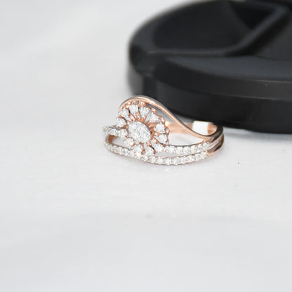 gold ring with diamond accents on a light gray surface