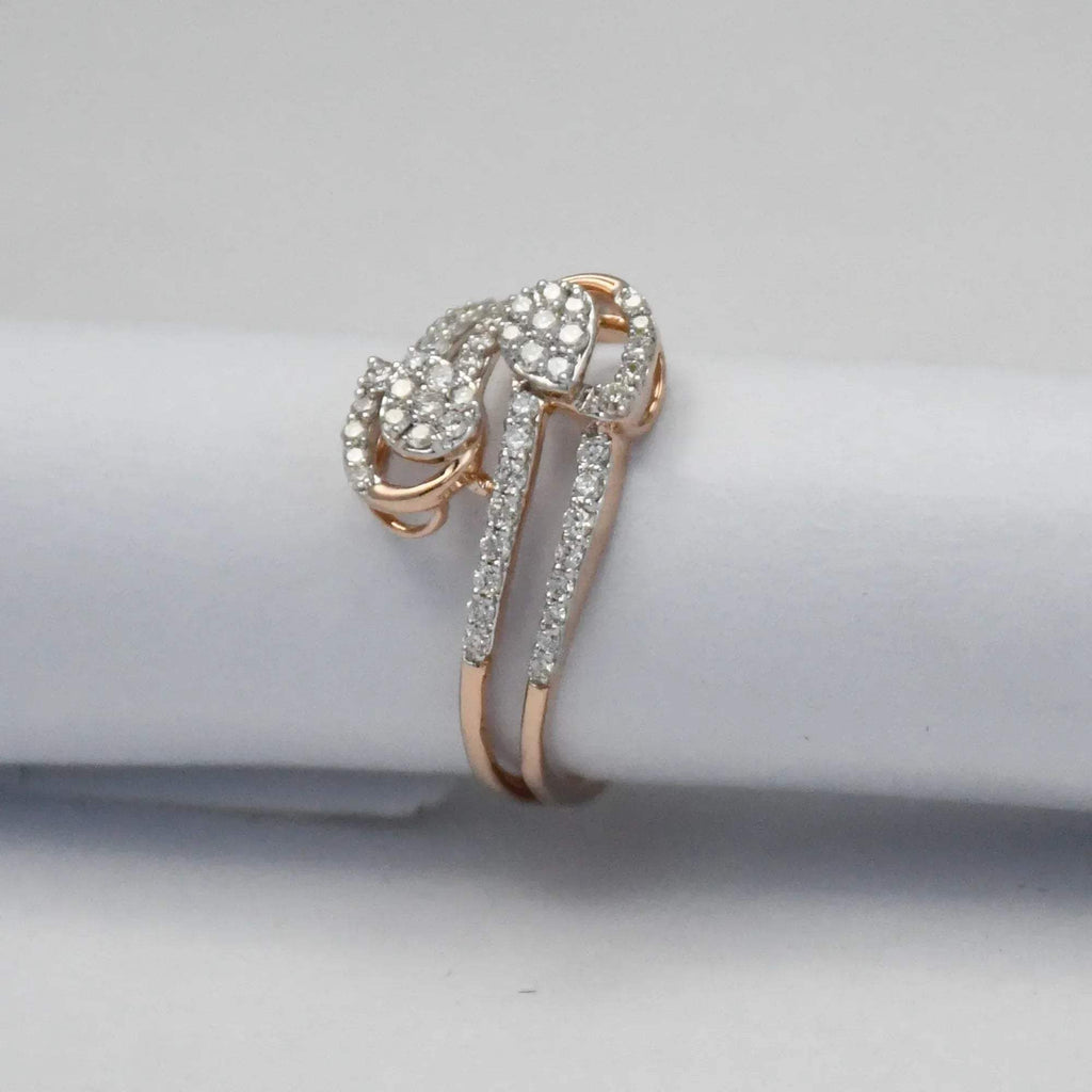 Rose gold ring with diamonds on a light gray background