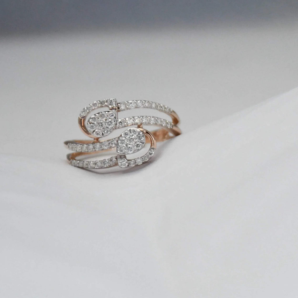 Rose gold ring with diamonds on a light gray background