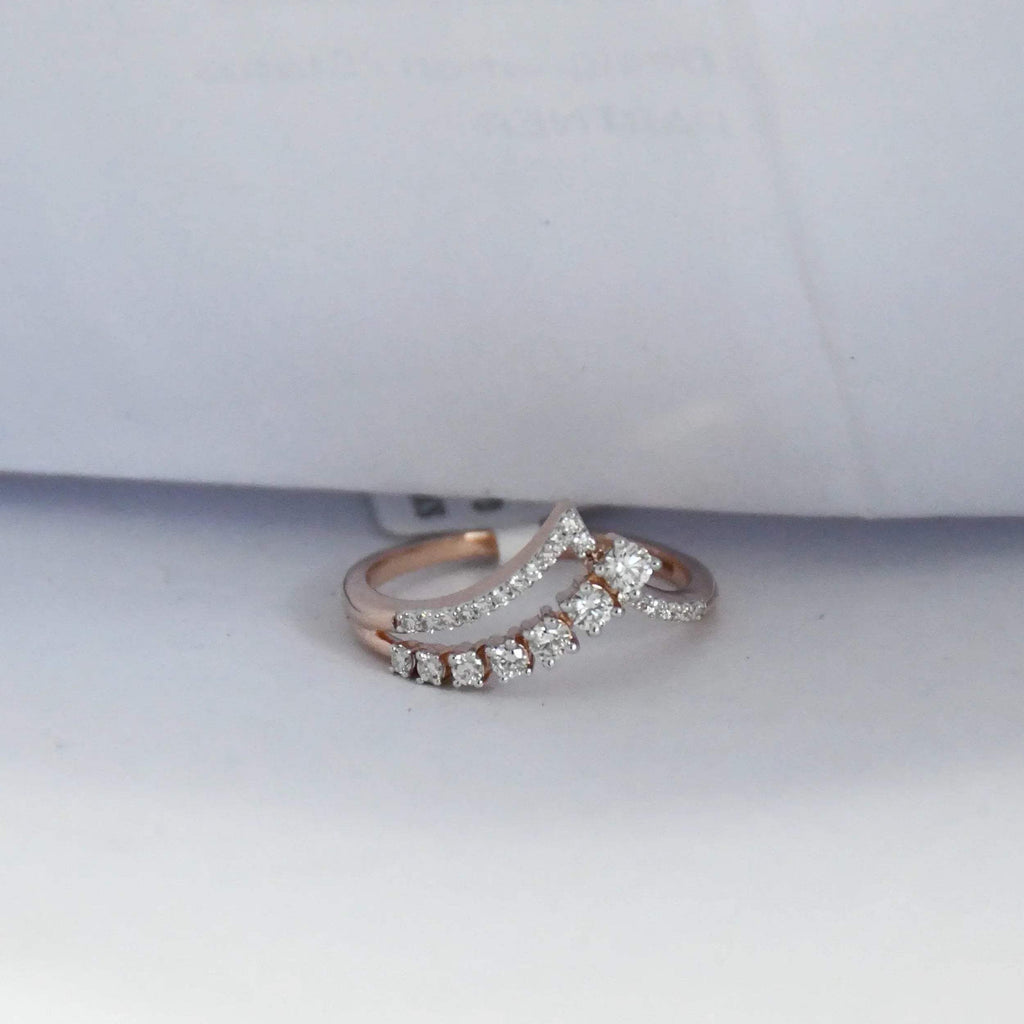 Rose gold ring with diamonds on a white background