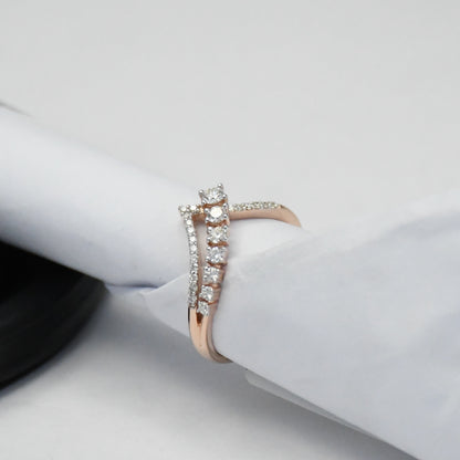 Rose gold ring with diamonds on a white surface