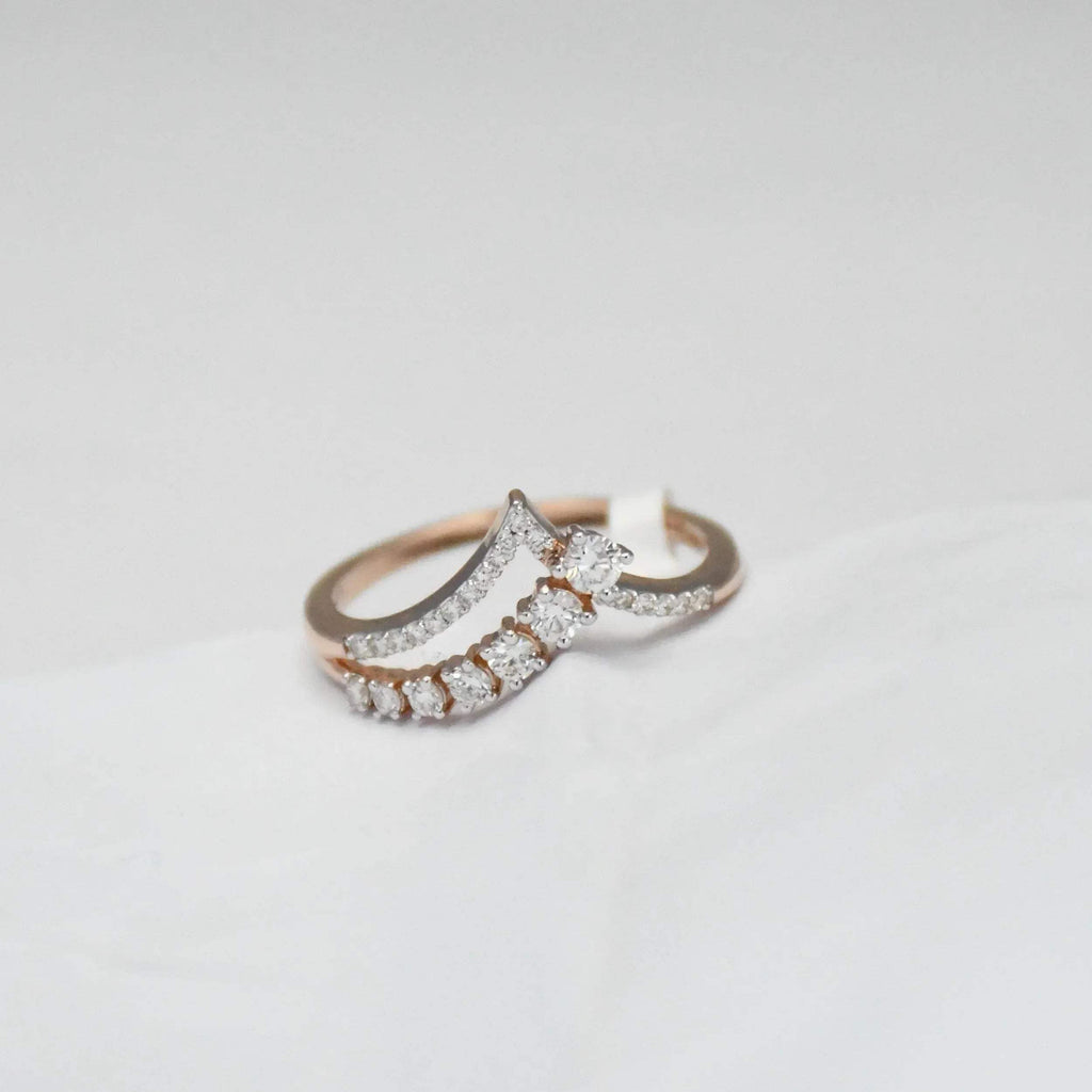 gold diamond ring on a light gray background