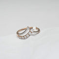 gold diamond ring on a light gray background