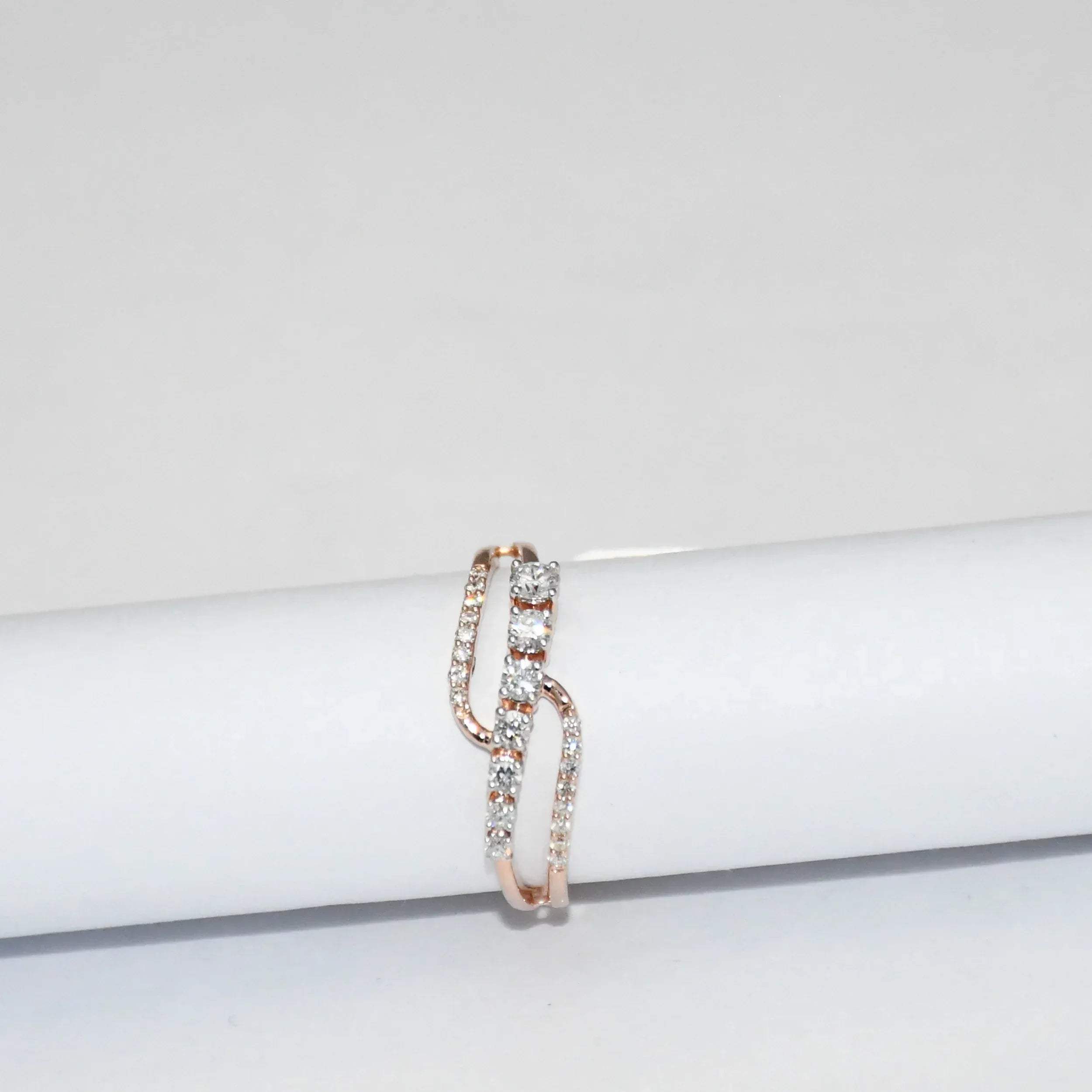 gold ring with diamonds on a white surface