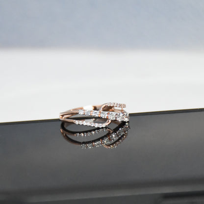 gold ring with diamonds on a reflective surface
