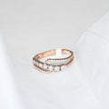 gold ring with diamonds on a light gray background
