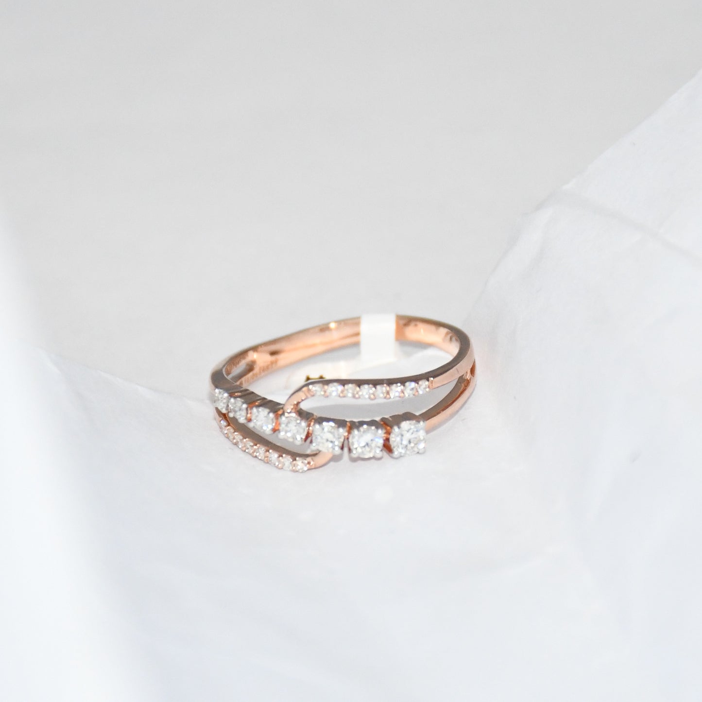 gold ring with diamonds on a light gray background