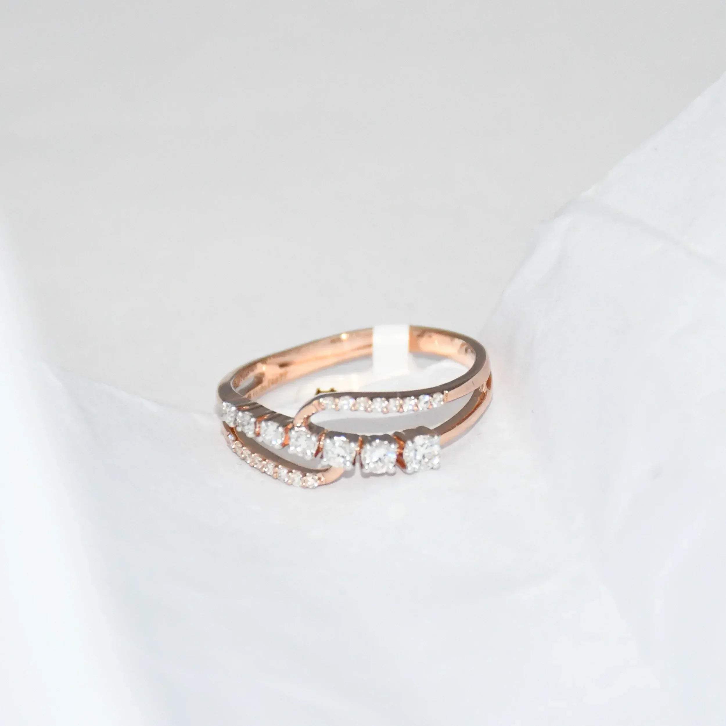 gold ring with diamonds on a light gray background