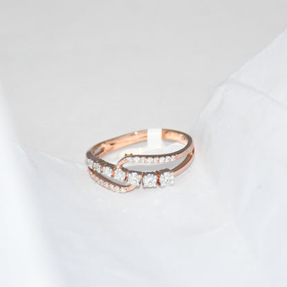 gold ring with diamonds on a light gray background