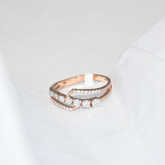 gold ring with diamonds on a light gray background