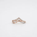 A delicate rose gold diamond ring set with diamonds, photographed on a clean white background.