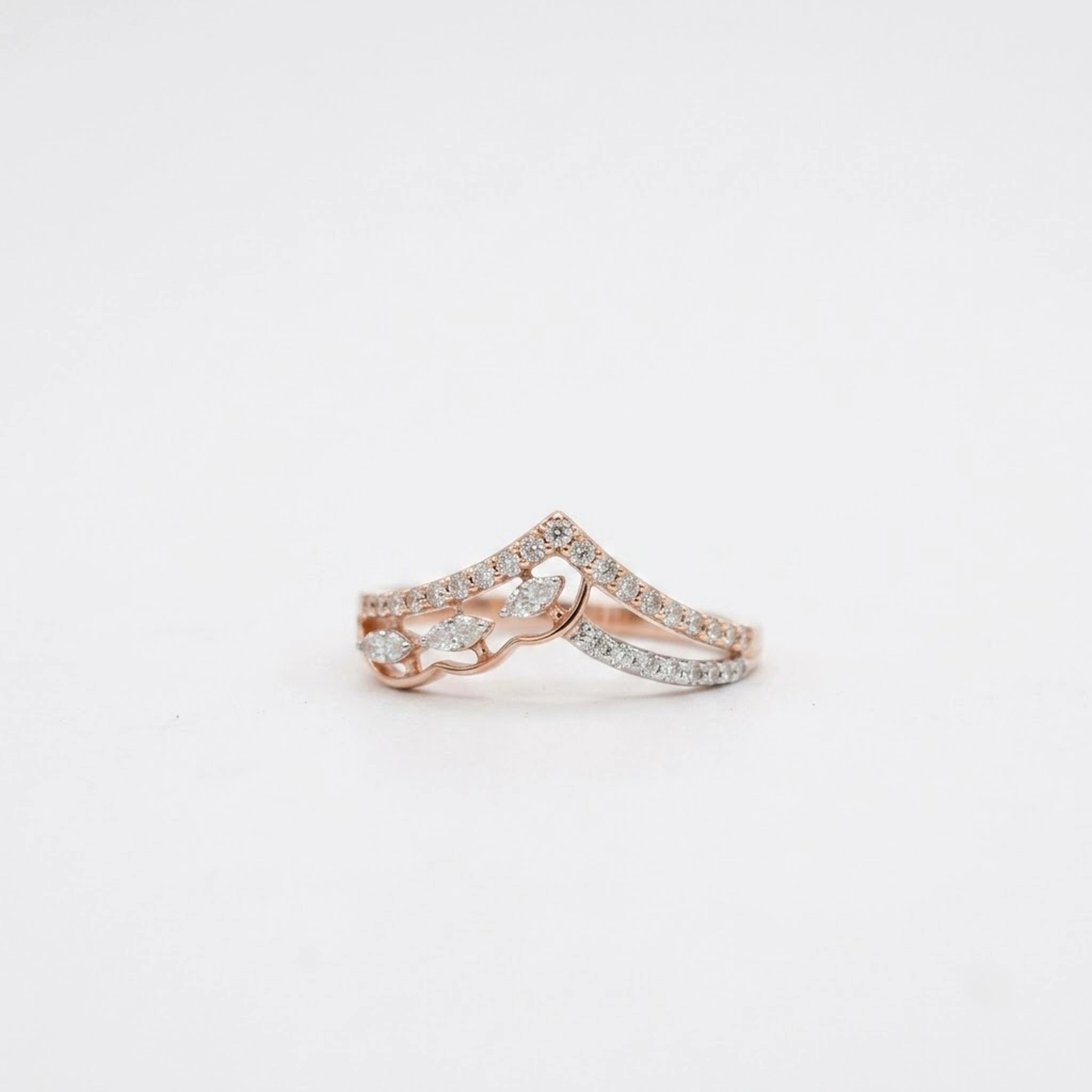 A delicate rose gold diamond ring set with diamonds, photographed on a clean white background.