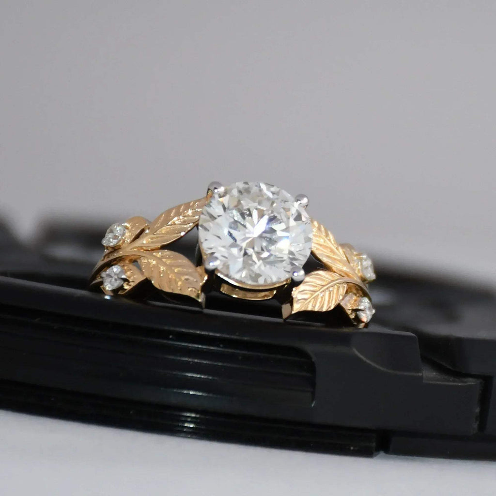 Gold ring with diamond on a black surface
