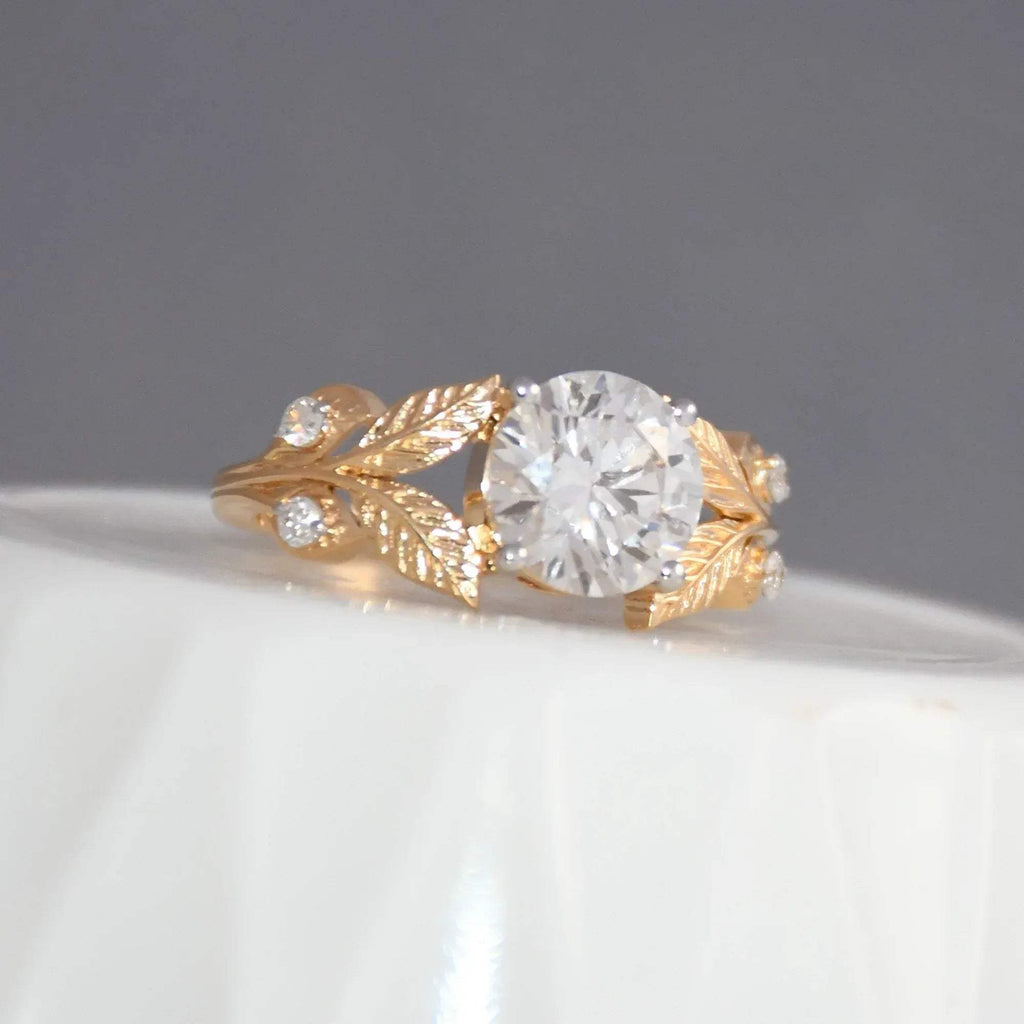 Gold ring with diamond on a gray background.