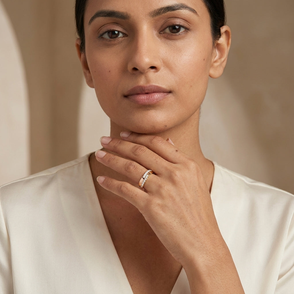 A two-tone gold diamond ring with alternating yellow and rose gold bands, set with multiple round-cut diamonds worn in a woman's finger.