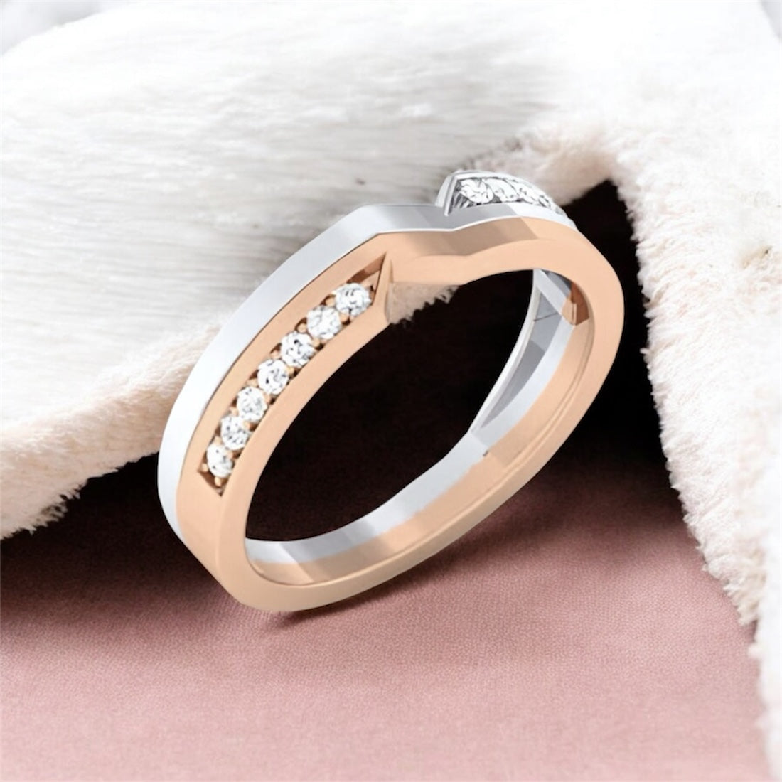 Two-tone ring with diamonds on a soft fabric background