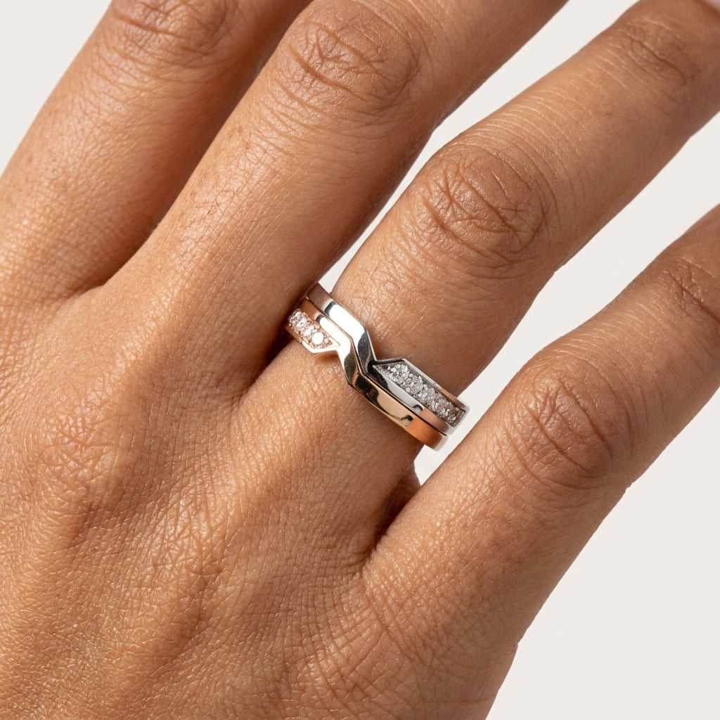 Close up of a two-tone ring with diamonds worn in a hand's finger