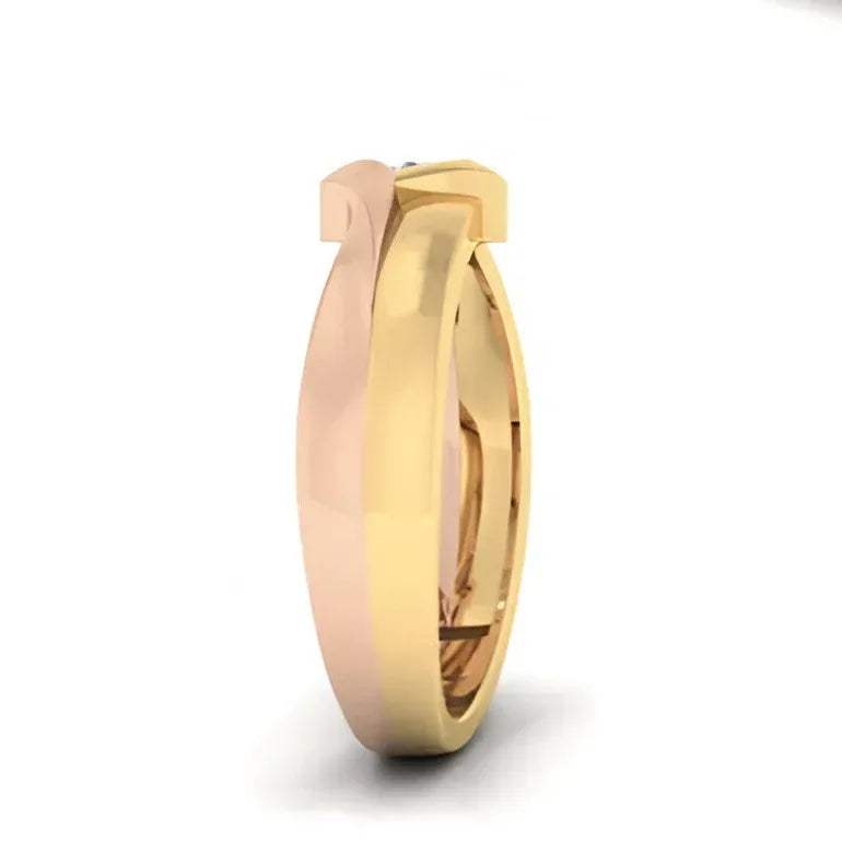 Two tone gold ring with a diamond on a white background