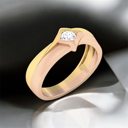 Two-tone gold ring with a diamond on a dark background