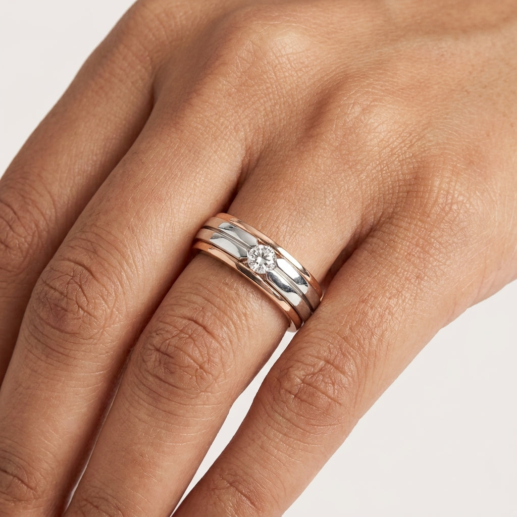 Close up of two-tone gold ring with a diamond in a hand's finger