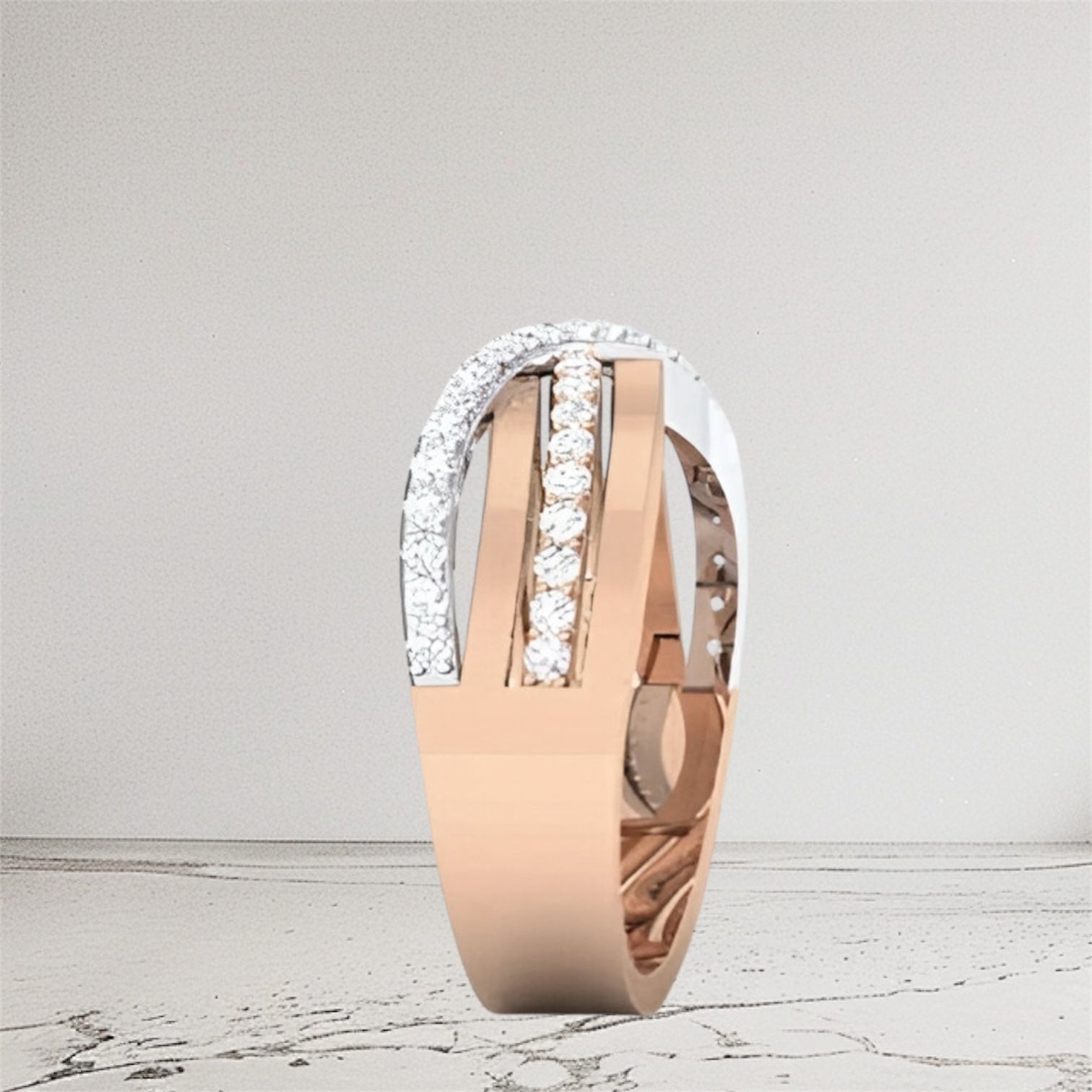 Rose gold ring with diamond accents on a light gray background