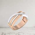 Rose gold and silver ring with diamond accents on a light gray background