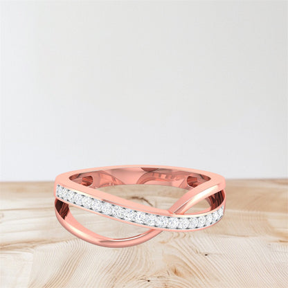 Rose gold ring with diamond accents on a light wooden surface