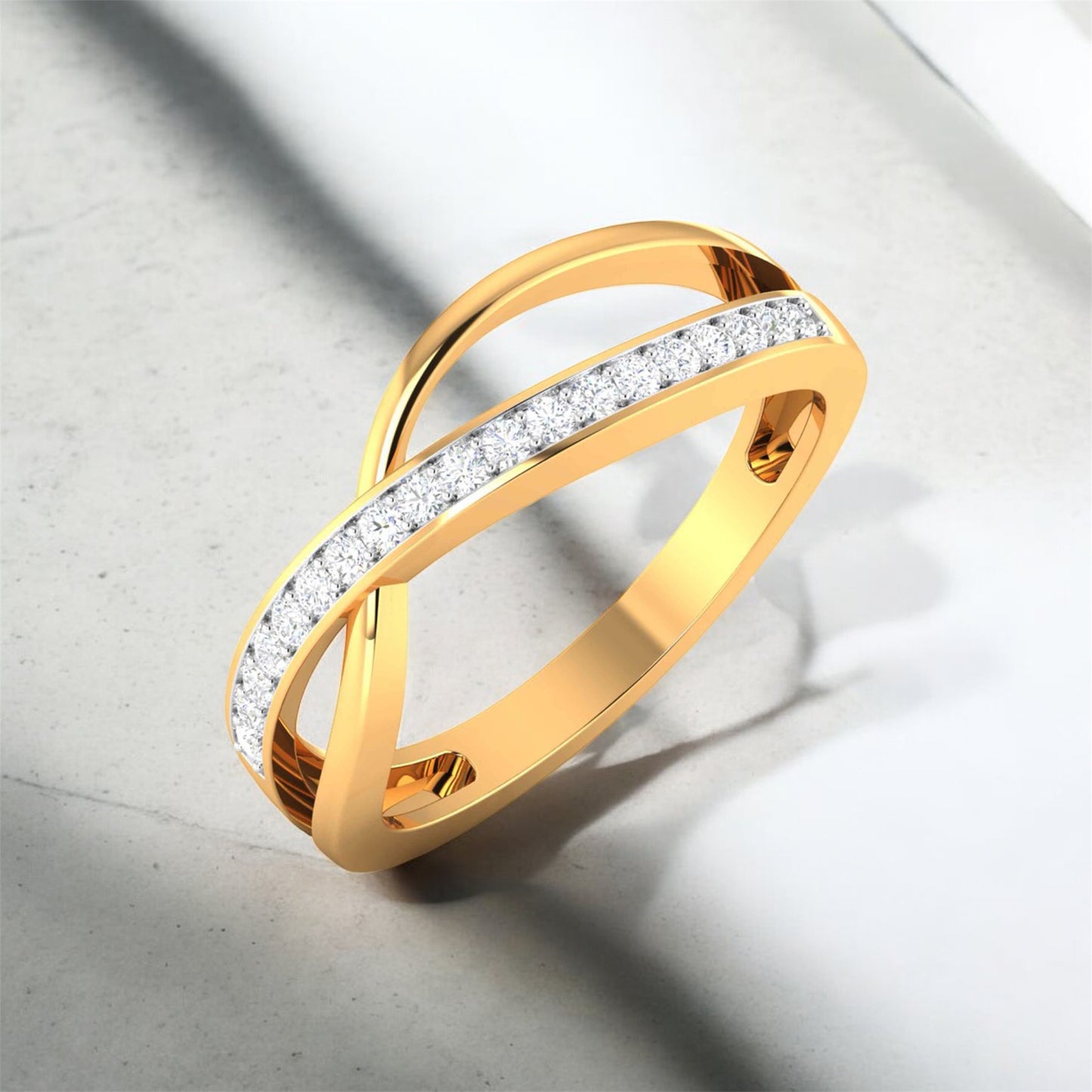 Gold ring with diamond accents on a light gray background