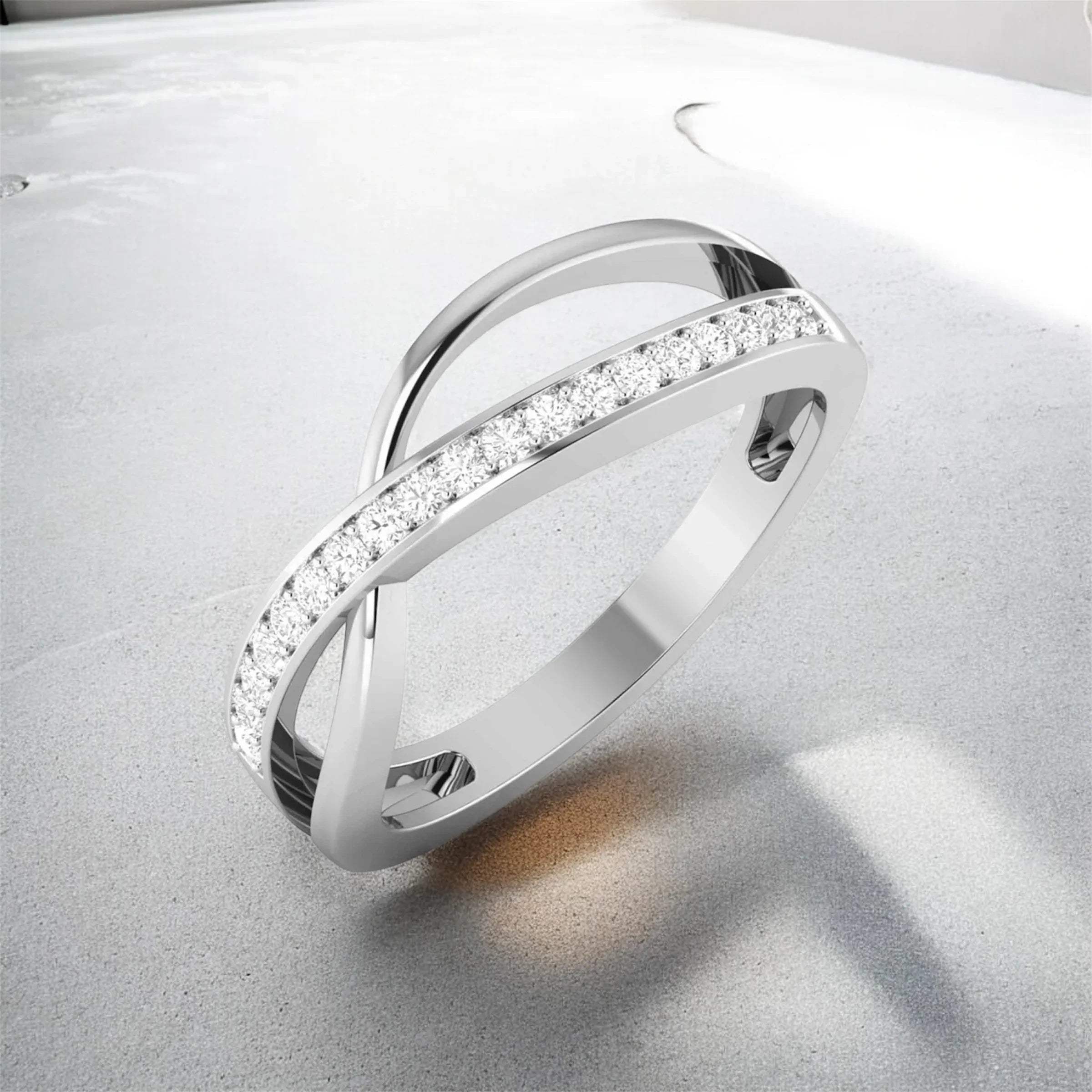 white gold ring with diamond accents on a light gray background