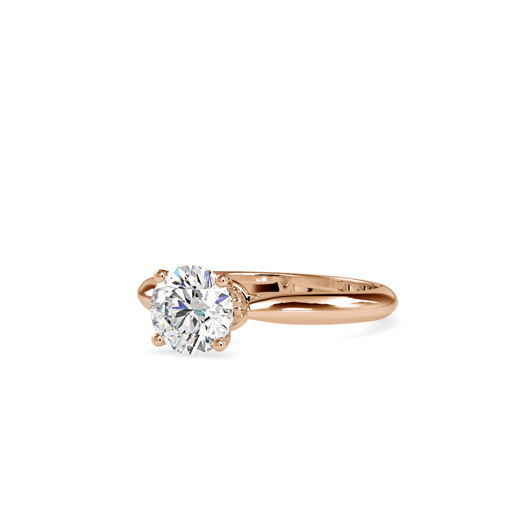gold ring with a solitaire diamond on a white background
