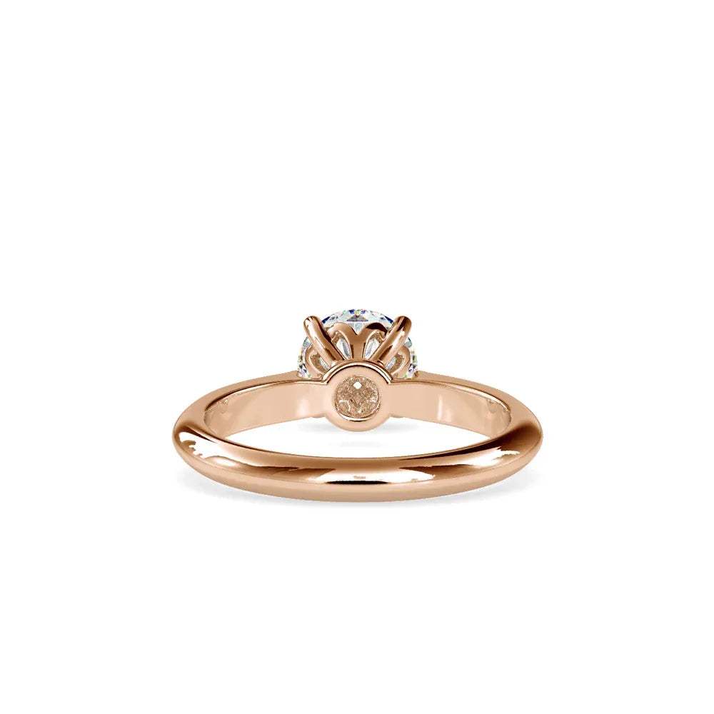 gold ring with a solitaire diamond on a white background