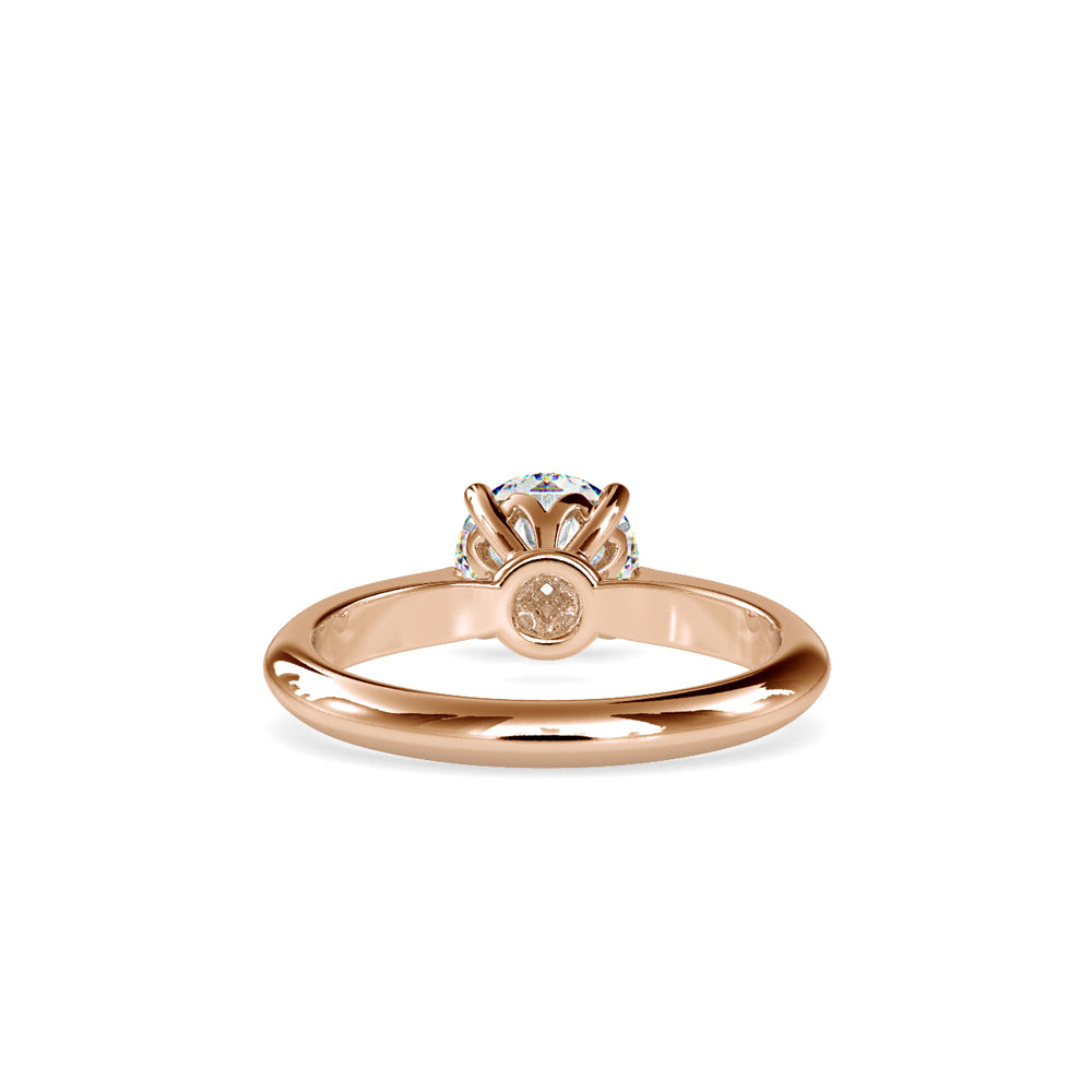 gold ring with a solitaire diamond on a white background