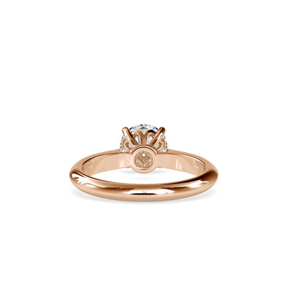 gold ring with a solitaire diamond on a white background