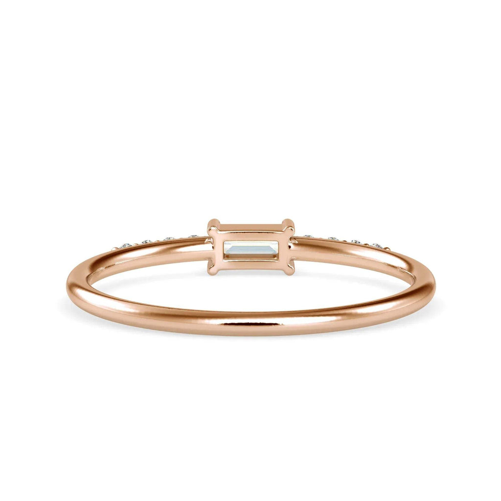 gold ring with a central diamond on a white background