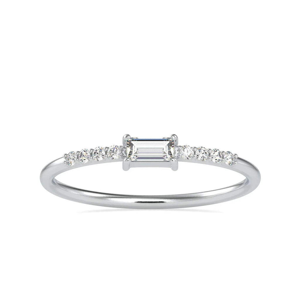 Diamond ring with a central emerald-cut diamond and smaller diamonds on a white background