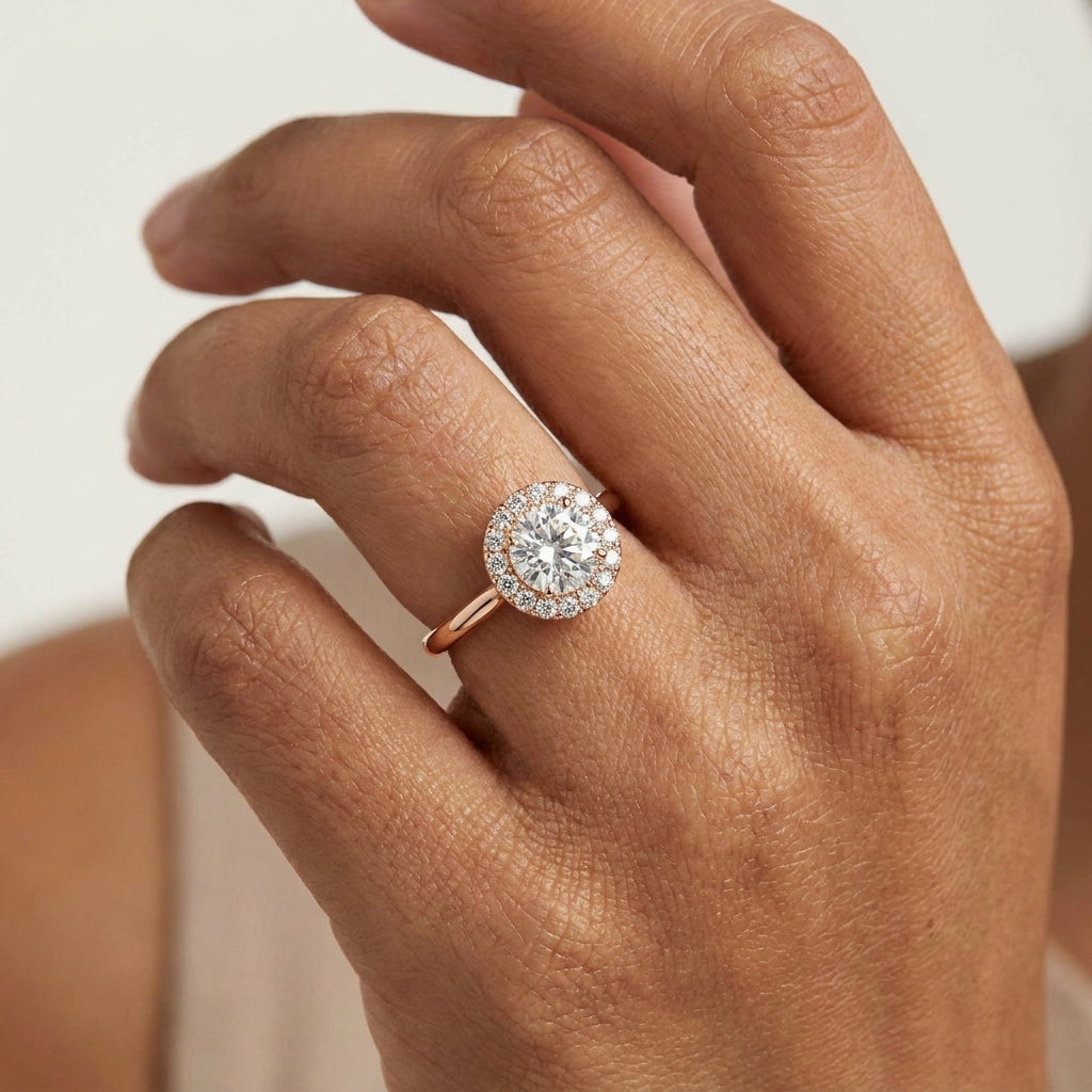 Rose gold ring with a diamond worn in a hand's finger