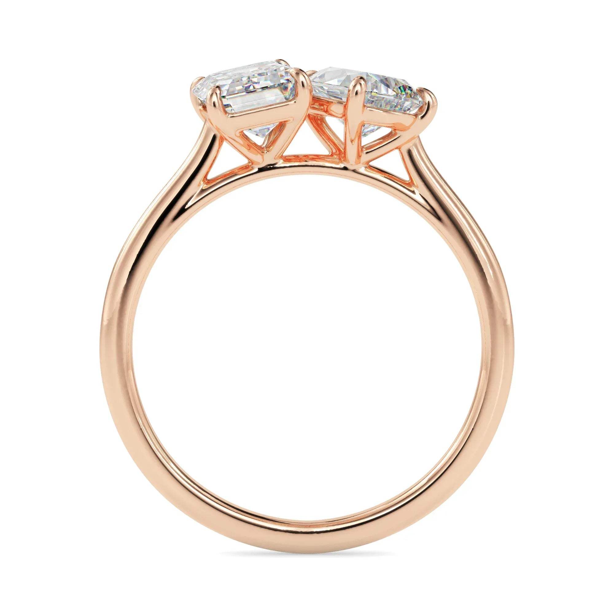 Rose gold ring with two diamonds on a white background