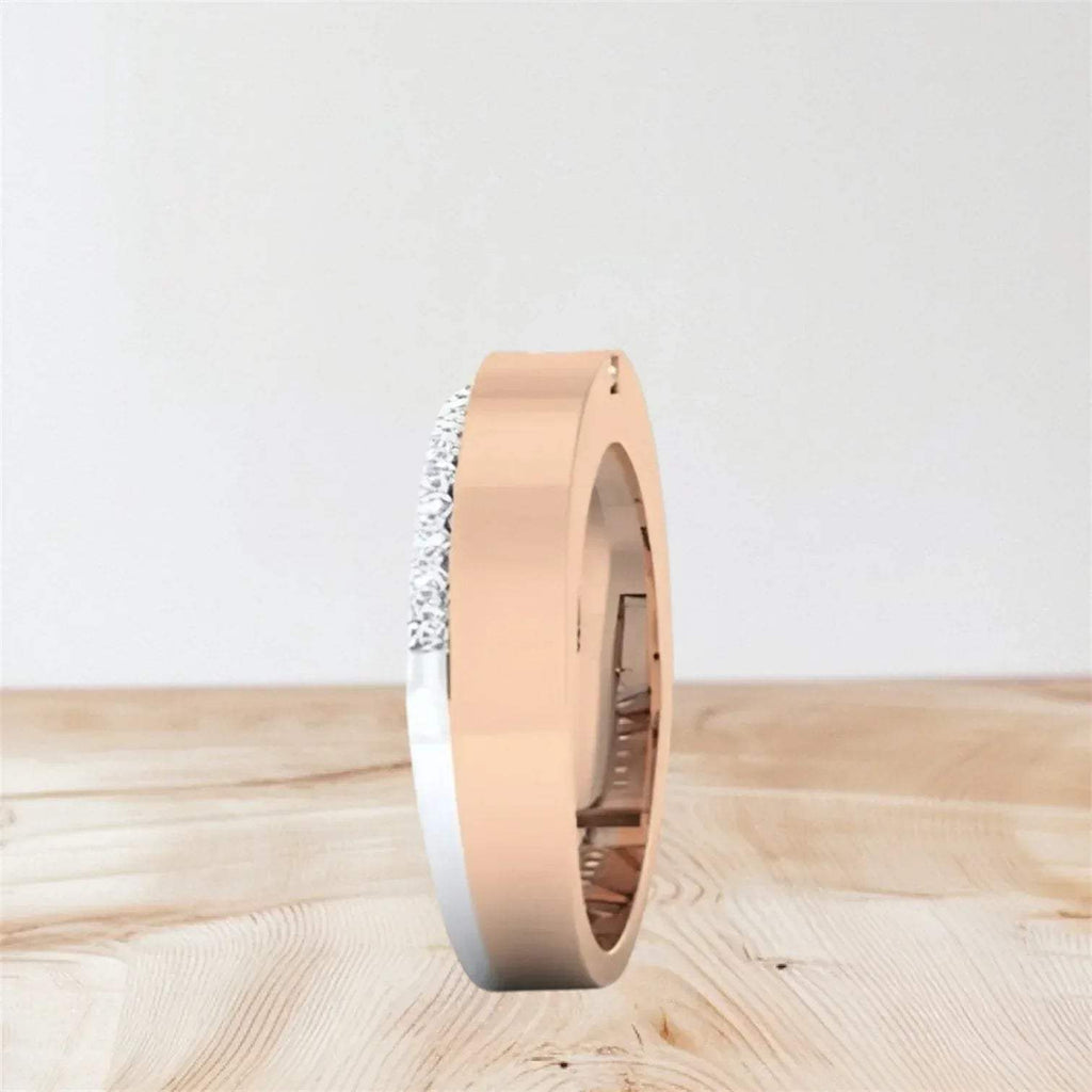 Rose gold ring with small diamonds on a light wooden surface